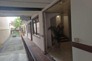 an empty hallway of a building with a potted plant at LA PERLE VERTE - Spacious studio near Papeete waterfront in Te Auae +26 photos