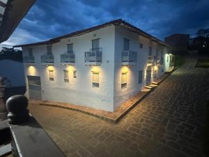 a white building with lights on the side of it at Casa Mónica Barichara in Barichara