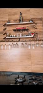 a wooden wall with wine glasses on it at Minha house in Navegantes