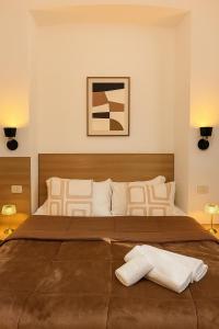 a bedroom with a large bed with two lamps at Hotel Aurelia Milano Centrale in Milan