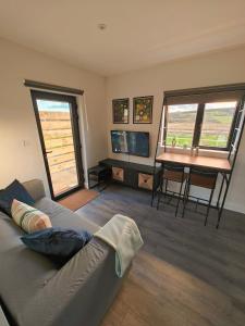 a living room with a couch and a table at Modern and peaceful, country retreat in Lahinch
