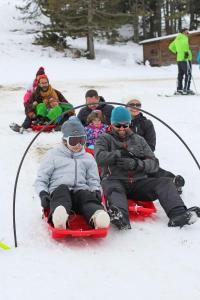 a group of people riding on a sled in the snow at Vue exceptionnelle tout en haut des montagnes, dépaysement total ! in Camurac