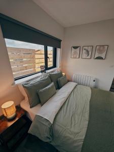 a bedroom with a large bed and a window at Modern and peaceful, country retreat in Lahinch