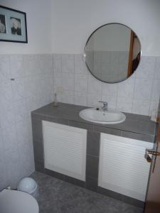 a bathroom with a sink and a mirror and a toilet at Ferienhaus Emma in Zinnowitz +11 photos