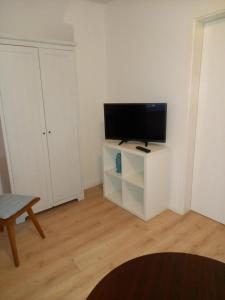 a living room with a flat screen tv on a stand at Ferienhaus Lukas in Zinnowitz +4 photos