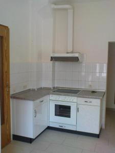 a kitchen with a white stove and a sink at Ferienwohnung Michel in Ahlbeck +6 photos