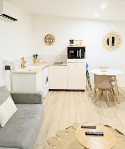 a living room with a couch and a table at Tiny House moderne et cosy in Vernouillet