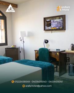 a hotel room with a desk and a bed and a computer at فندق عرفه الجديد in Tanta