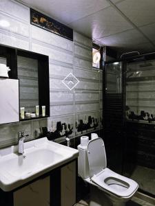 a bathroom with a toilet and a sink at ALYA RUM LUXURY Camp in Wadi Rum