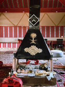 a black hat with a crest on it in a room at ALYA RUM LUXURY Camp in Wadi Rum