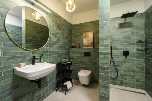 a bathroom with a sink and a toilet and a mirror at 4 Strony Lasu in Gołaczów