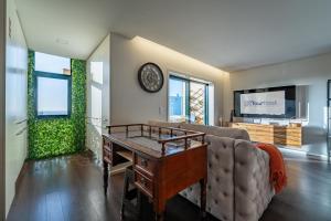 a living room with a couch and a table at Sun, Sea, and Comfort Apartment in São Félix da Marinha