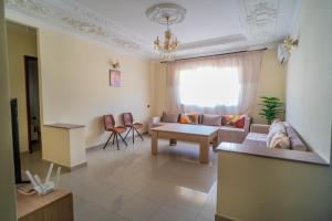 a living room with a couch and a table at RESIDENCE Al SALAM in Tangier