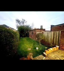 a backyard with a yard with a fence and a yard at Edgware, Haru Residence 4bed House in Wealdstone