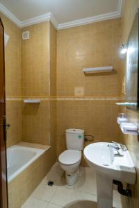 a bathroom with a toilet and a tub and a sink at RESIDENCE Al SALAM in Tangier +36 photos