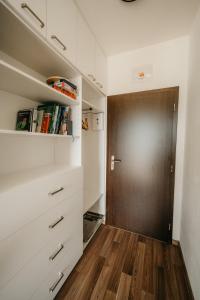 a closet with a wooden door in a room at Rezidence Rokytnice in Rokytnice nad Jizerou