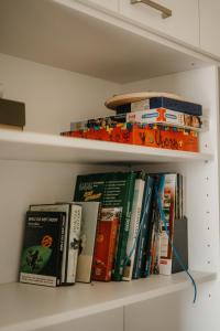 a bunch of books sitting on a shelf at Rezidence Rokytnice in Rokytnice nad Jizerou