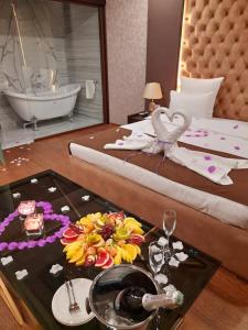 a hotel room with a bed with a table with a plate of food at Via Ggio hotel in Yerevan