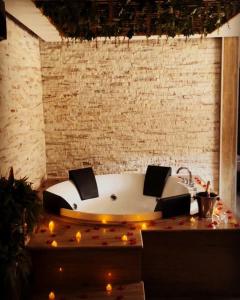 a bath tub in a room with lights around it at Via Ggio hotel in Yerevan