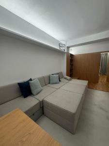 a living room with a couch with blue pillows at Central & Modern Apartment in Banská Bystrica