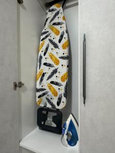 a tie is hanging on a wall next to a door at Апартаменты Парковые озера in Kyiv