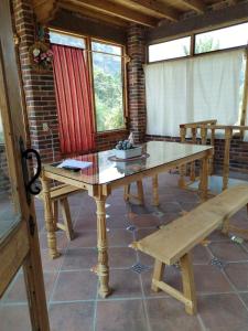 a dining room with a table and a bench at Chalmita de mis amores 