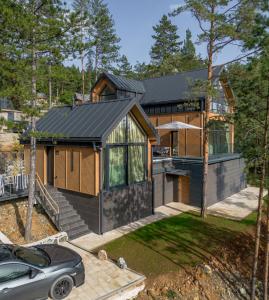 a house with a black roof at 3 Tačke Tara in Zaovine +57 photos