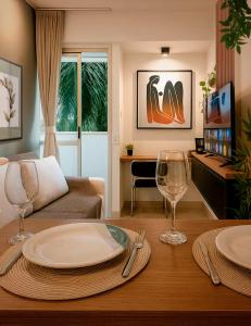 a living room with a table with plates and wine glasses at Apê super charmoso! Ar-condicionado e piscina in Brasilia