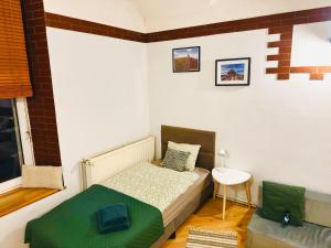 a small bedroom with a bed and a table at Apartament przy Starej Hucie in Szklarska Poręba