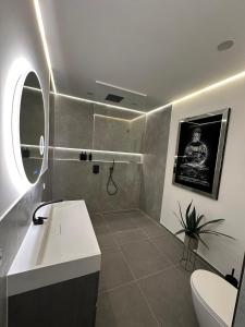 a bathroom with a sink and a toilet and a window at Good Vibes Luxury Homes in Kaiserslautern