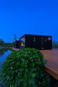 een huis met een vijver en een houten terras bij Vila Gramado in Gramado