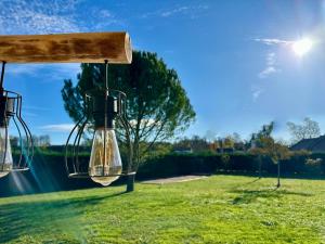 a pair of lanterns hanging in a field at La Dolce Casa en M in Névy-lès-Dole
