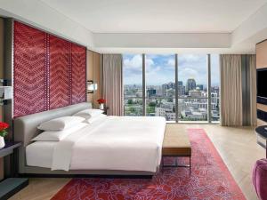 a bedroom with a large bed and a large window at Sofitel Beijing Central in Beijing