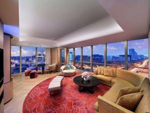 a large living room with a couch and a table at Sofitel Beijing Central in Beijing +92 photos