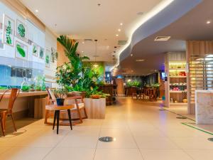 a restaurant with tables and chairs and plants at ibis Styles Curitiba Aeroporto in São José dos Pinhais +103 photos