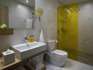 a bathroom with a toilet and a sink and a shower at ibis Styles Athens Routes in Athens +132 photos