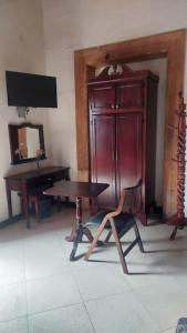 a room with a desk and a wooden cabinet and a table at La Casona de los Gómez in Zacatlán +29 photos