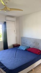 a bedroom with a blue bed with a ceiling at Apartment in Cupecoy