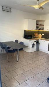 a kitchen with a table and chairs and a microwave at Apartment in Cupecoy