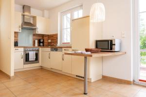 a kitchen with a counter with a microwave on it at Ferienhaus Marvin In Beckerwitz in Gramkow