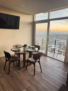 a dining room with a table and chairs and a large window at Luxury apartment with panoramic view in tower in Laborcillas