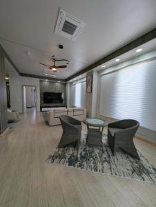 a large living room with a table and chairs at ICHA Apartments in Suva