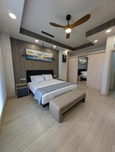 a bedroom with a bed and a ceiling fan at ICHA Apartments in Suva