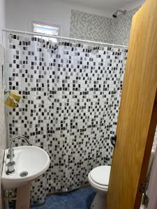 a bathroom with a sink and a toilet and a shower at La Perla del Yuqueri in Concordia +12 photos