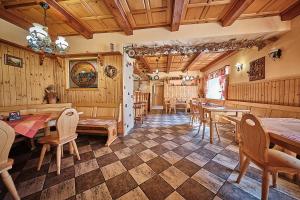 a dining room with wooden walls and tables and chairs at Rezidence Jih in Hlavňovice