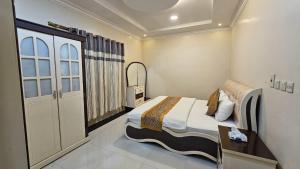 Ένα ή περισσότερα κρεβάτια σε δωμάτιο στο شقق أجمل الليالي للشقق المخدومة Ajmal Liyali Serviced Apartments