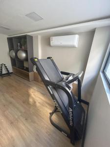 a gym with a treadmill and a fan in a room at Aurea 310 in Tambaú +18 photos
