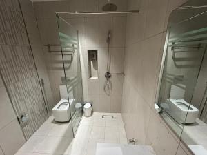 a bathroom with two toilets and a shower at قمرة قباء Quba moon3 in Al Madinah +2 photos