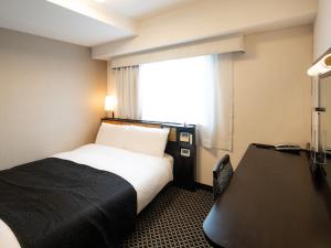 a hotel room with a bed and a window at APA Hotel Ueno Ekikita in Tokyo +43 photos