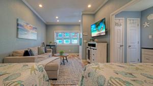 a bedroom with two beds and a living room at 2 Pools Beach Boardwalk Access Studio Sleeps 5 Beach Bungalow by AvantStay in Port Aransas